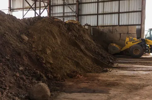 Medium view of soil pile with equipment